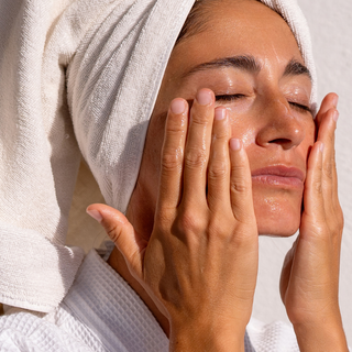 Woman cleansing face