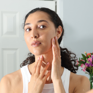 Woman examining her skin