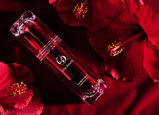 Thursty Skin™ bottle laying amongst Hibiscus flowers