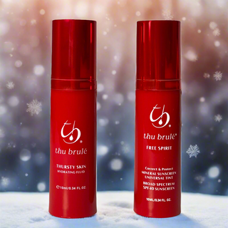 Two red Thu Brulé bottles with a winter background